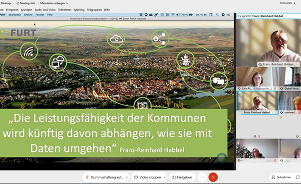 Auf einem Bildschirmfoto ist der Text "Die Leistungsfähiugkeit der Kommunen wird davon abhängen, wie sie mit Daten umgehen" zu lesen. Daneben Teilnehmer einer Onlinekonferenz.