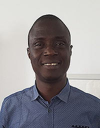 The integrated expert Lancine Kouyaté smiles into the camera.
