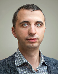 The integrated expert Serhij Lukanjuk smiles into the camera.